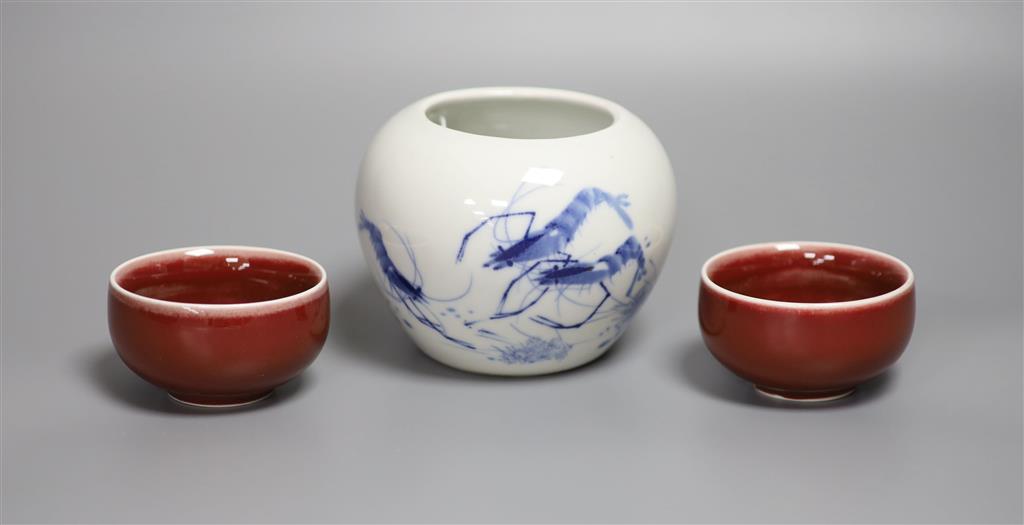 A Chinese blue and white water pot and two sang de boeuf glazed cups, tallest 9cm